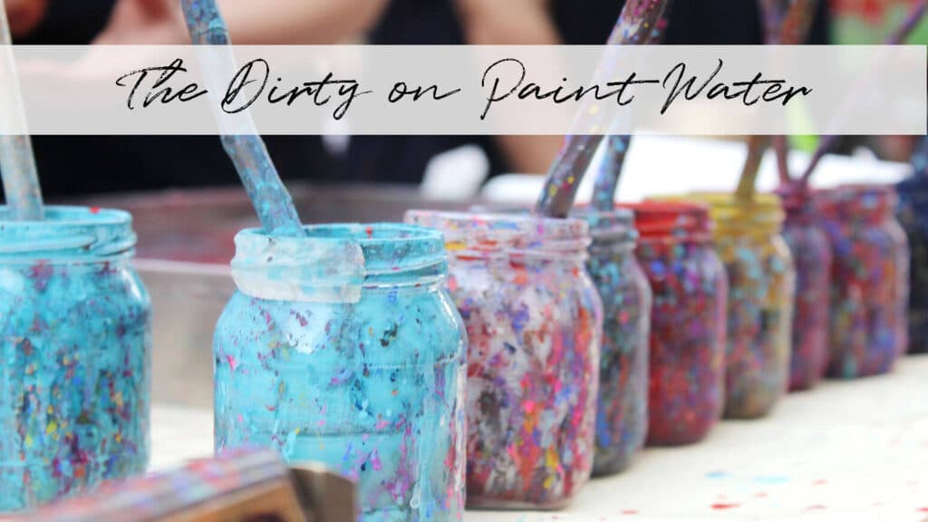 A row of mason jars, with dried colorful paint all over them, holding dirty paint water.