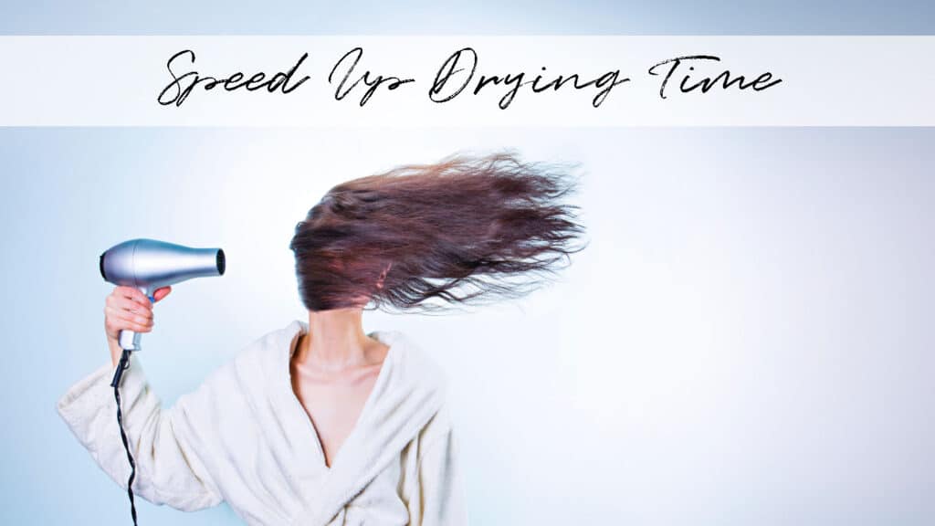 A woman in a bathrobe, holding a hair dryer, with her hair flying out to the side and titled "Speed Up Drying Time"