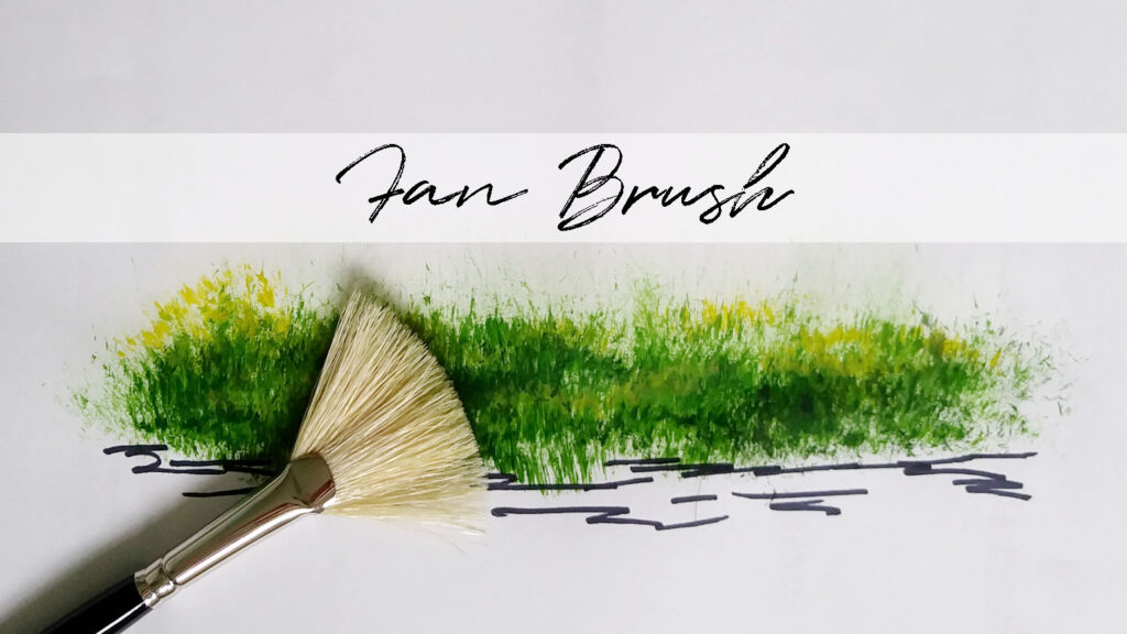 Green grass, on the bank of a river, that was painted using the fan brush that's shown.