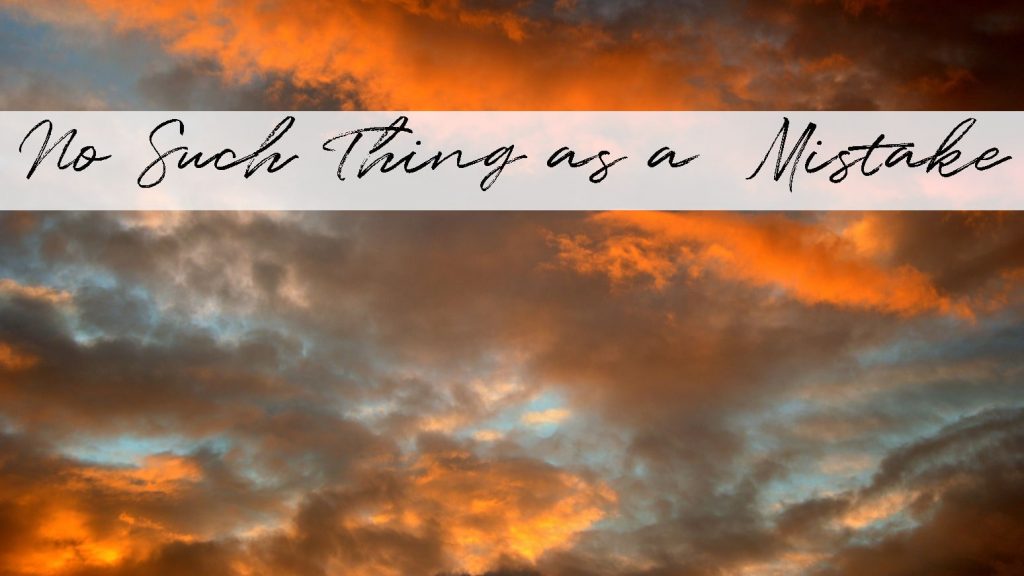 A sky filled with clouds, reflecting the sunset colors of orange and yellow. There is an extra space added just before the word "Mistake" in the title "No Such Thing as a  Mistake" as an example of how what may seem like a mistake can actually add to the overall message/style you are trying to get across.
