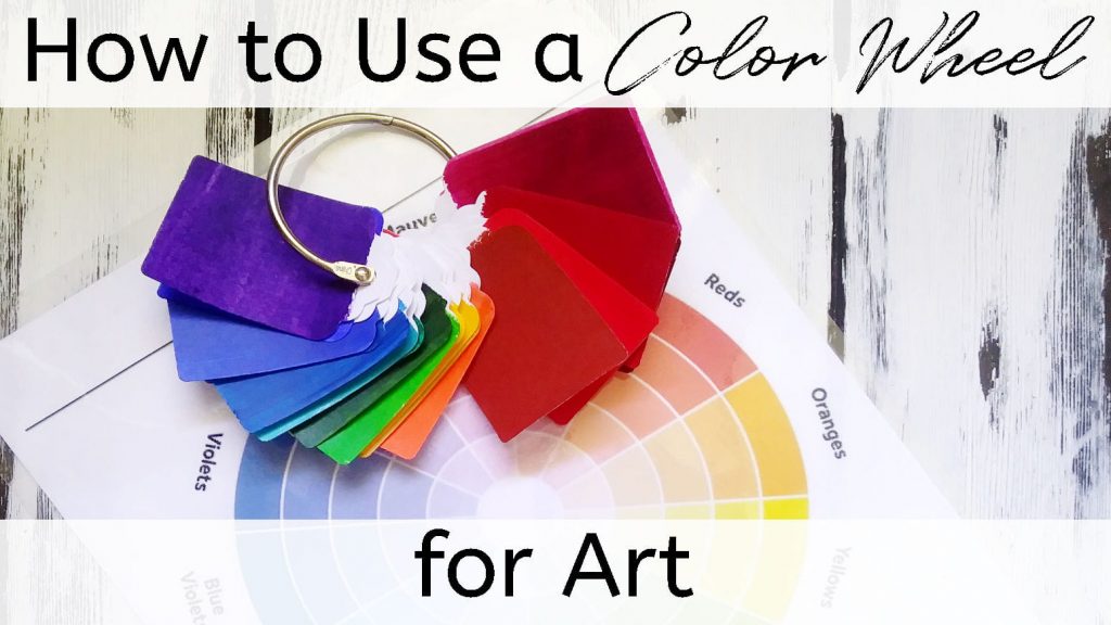 A color wheel and paint chips in every color of the rainbow that represents how to use a color wheel for art.