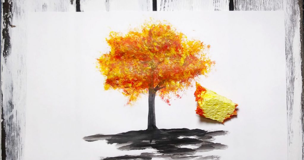 A tree with yellow and orange fall leaves made by using a kitchen sponge.