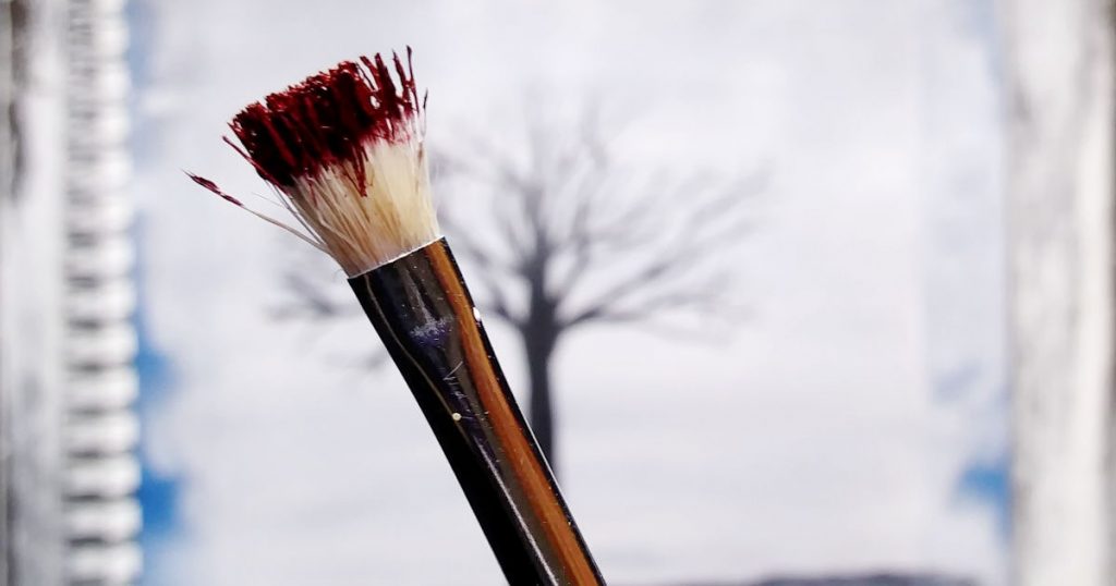 A cheap paintbrush with rough bristles that are splayed out. Perfect brush to paint fall leaves!