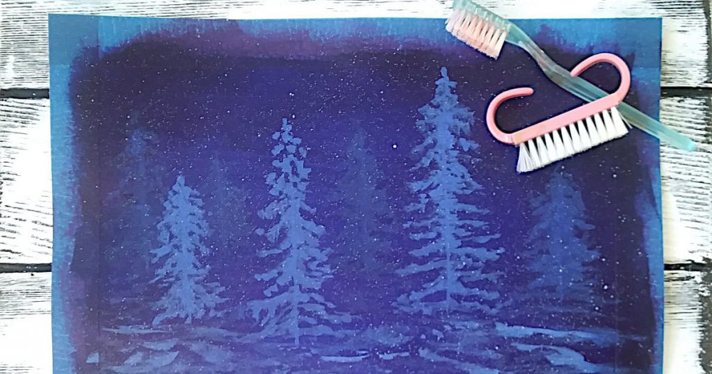 The same dark blue landscape painting with very small snowflakes splattered onto the surface using either a toothbrush or a nailbrush