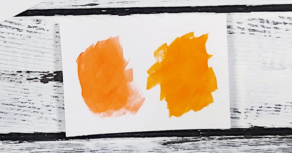 A paint swatch showing two different oranges from different brands that are very similar and could be used as alternative paint colors