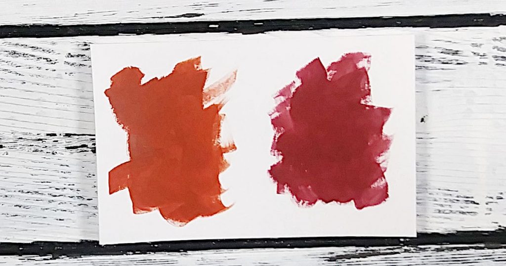 A color swatch showing the slight difference between red oxide and barn red acrylic paint