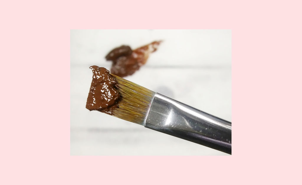 Gritty looking Burnt Umber paint on a paintbrush