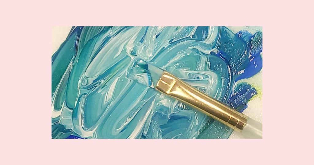 Blue, green, and white paint swirled together with a flat paintbrush to show different levels of turquoise you can make.