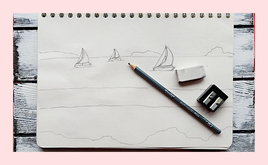 A sketch of three sailboat and a large wave with a pencil, eraser, and pencil sharpener on top of the sketch. A very simple sketch is one of the first steps in planning your artwork.