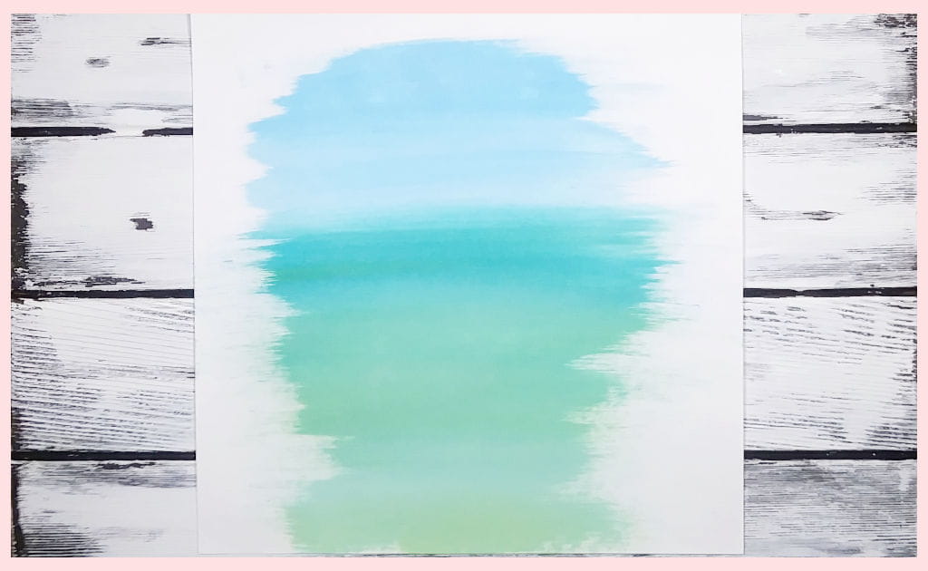 Blended acrylic paints in different shades of turquoise to demonstrate how to paint the background