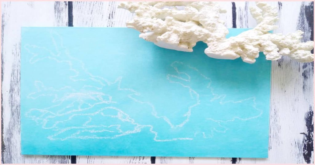 A chalk outline of the white imitation reef coral onto the turquoise painted canvas.