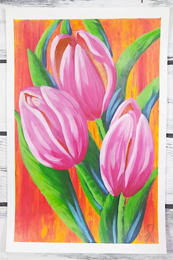 A painting by Sara Dorey, owner of Squishing Paint, of three pink tulips with bright green leaves on an orange and deep yellow background.