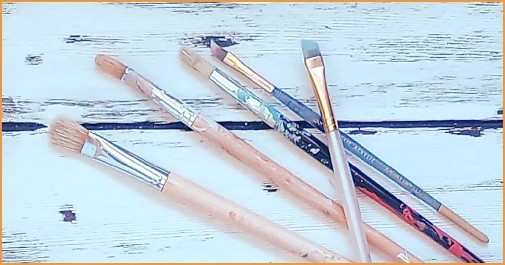 A pile of both extra firm bristle and old scruffy paintbrushes.
