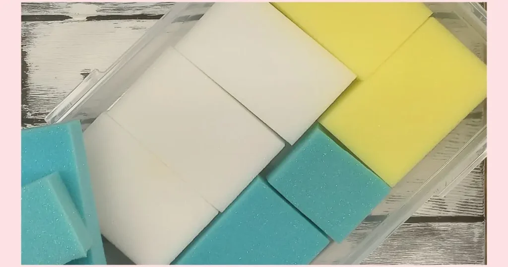 Turquoise, white, and yellow sponges cut to fit inside the plastic container.