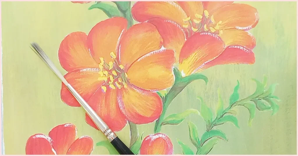 A rigger brush on an orange floral background.