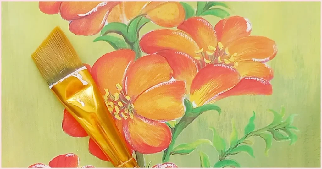 An angle paint brush laying atop an orange floral background.