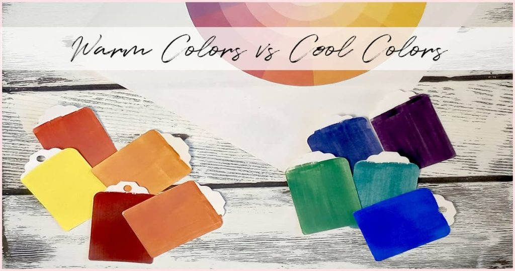 Various red, yellow, orange, green, blue, and purple paint chips separated into piles of warm colors and cool colors.