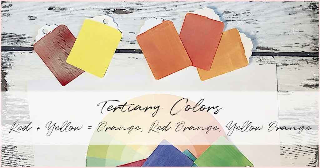 Red, yellow, and various tones of orange on a white-washed wooden background. An example of mixing primary colors with secondary colors to create tertiary colors.